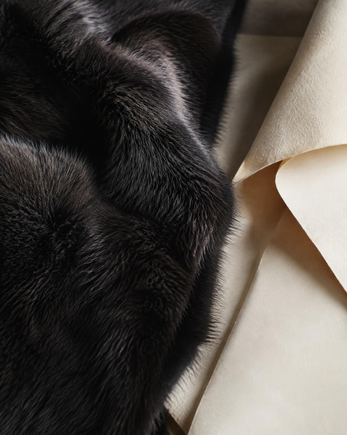 Close detail of dark fur and ivory pattern paper
